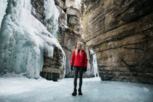 Woman doing an icewalk in a canyon